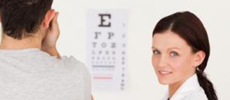 eye care practitioner smiling during eye exam