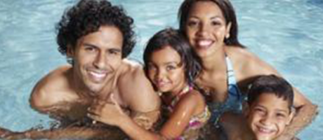 family smiling and swimming