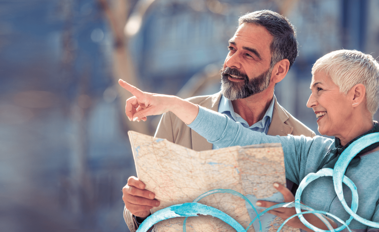 man and woman smiling and holding a map