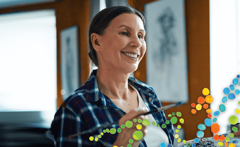 mature woman smiling and painting