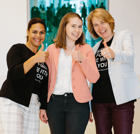 CooperVision employees giving a thumbs up