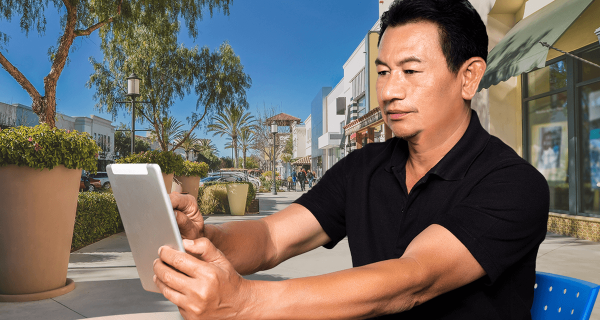 man holding a tablet and smiling