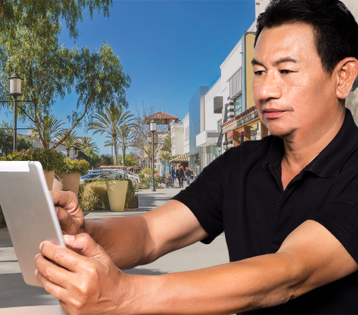 mature man holding a tablet