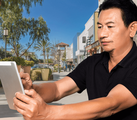 man holding a tablet and smiling